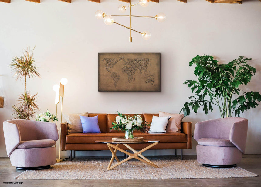 Carved wood artwork of the world map, featuring country names in a living room.