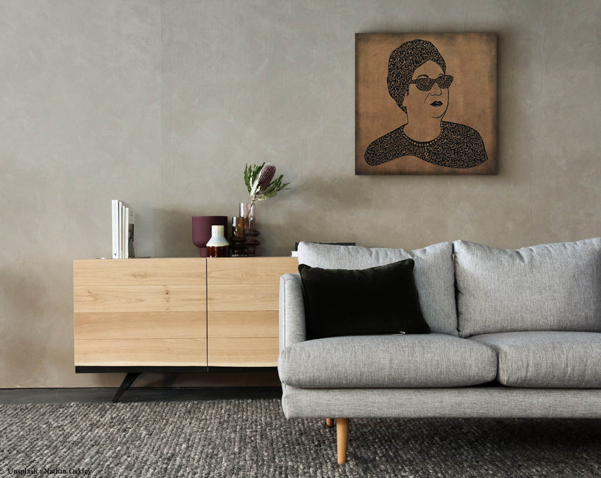 Carved wood portrait of Umm Kulthum with “Enta Omri” lyrics in living room.