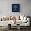 Wooden artwork of an olive tree with the quote “We will remain as long as thyme and olives remain.”  in a living room