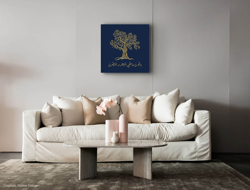 Wooden artwork of an olive tree with the quote “We will remain as long as thyme and olives remain.”  in a living room