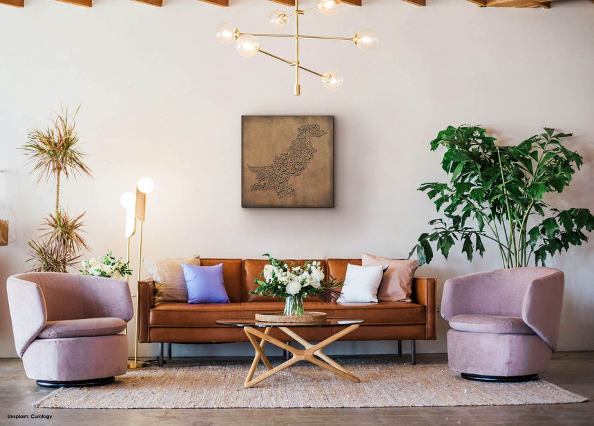 Carved wood artwork of the Pakistan map, featuring the names of its cities in a living room.