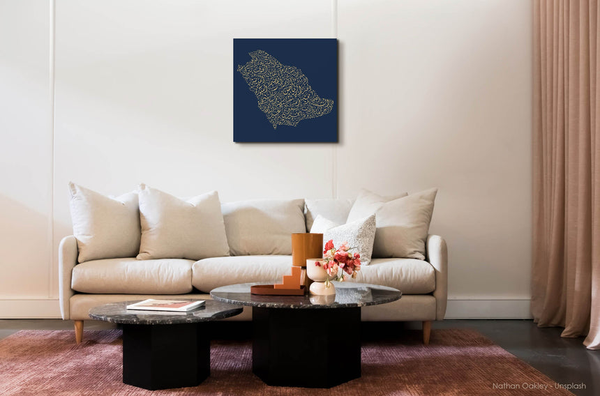 Carved wood artwork of the Saudi Arabia map, drawn in Diwani calligraphy using the names of its cities, in a living room setting