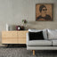 Carved wood portrait of Umm Kulthum with “Enta Omri” lyrics in living room.