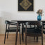 Carved wooden artwork of Surah Al-Ikhlas in a living room