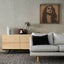 Carved wood portrait of Fairuz with “Bhebbak Ya Lebnan” lyrics in a living room.