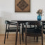 Carved wooden artwork of Surah An-Nas in a living room