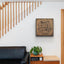 Wooden artwork with the Quranic verse “With hardship comes ease” in a living room.