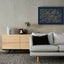 Carved wooden artwork featuring Quran 2:216 in the living room