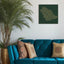 Carved wood artwork of the Saudi Arabia map, drawn in Diwani calligraphy using the names of its cities, in a living room setting with a plant