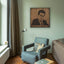 Carved wood portrait of Farid al-Atrash with “Ya Habaybi Ya Ghaybin” in a living room.