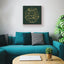 Wooden artwork with the Quranic verse “With hardship comes ease” in a living room.