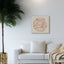 Wooden artwork with the Quranic verse “With hardship comes ease” in a living room.