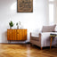 Carved wooden artwork Quranic verse 53:39 — “And that man will have nothing except what he strives for,” in a living room.