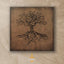 Carved wood artwork of an olive tree with the Arabic phrase “The land is ours, and to it we return.”