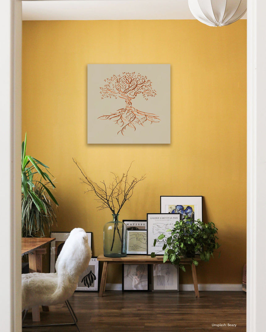 Wooden artwork of an olive tree with the Arabic phrase “The land is ours, and to it we return.” in a living room.