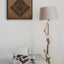 Carved wooden artwork of Surah Al-Falaq in a living room.