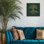 Wooden artwork of an olive tree with the Arabic phrase “The land is ours, and to it we return.” in a living room.